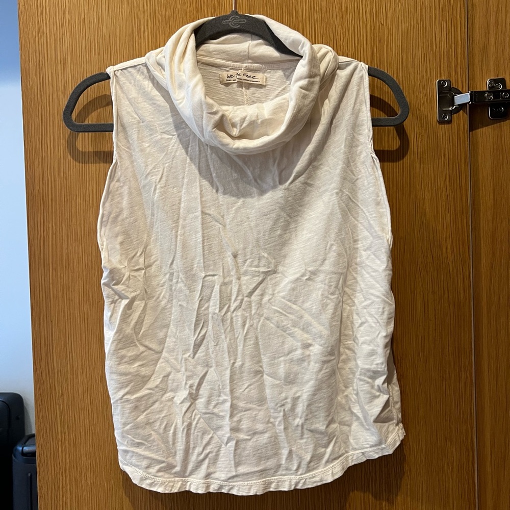 White sleeveless blouse with slight turtle neck